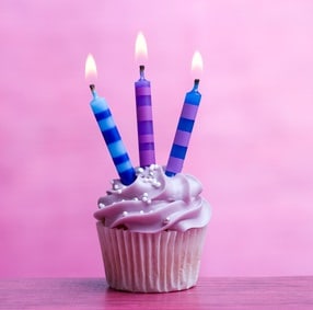 Cupcake decorated with three birthday candles